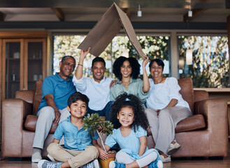 Happy family, children and grandparents for home insurance, investment and safety or growth with mom and dad. Kids on floor, interracial people and cardboard roof, house cover and security portrait