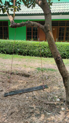 old swing made of scrap wood and rope