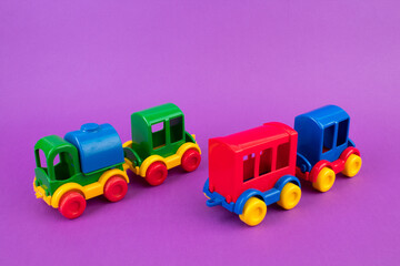 Children's toy, a multi-colored steam locomotive on a purple background.