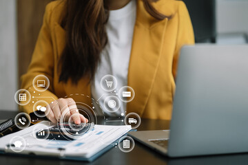 Businesswoman working with laptop and using a calculator to calculate the numbers of static in...