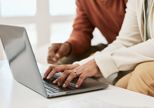 Hands, closeup and a couple with a laptop for internet, connection or research. Table, home and people typing on a computer for mortgage information, email or together for a movie online on a pc