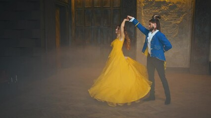 Halloween party dance fairy tale Prince and princess costume. Happy couple dancing at carnival ball. Fantasy beauty woman smiling spinning yellow dress fly in motion with Man beast, blue retro jacket