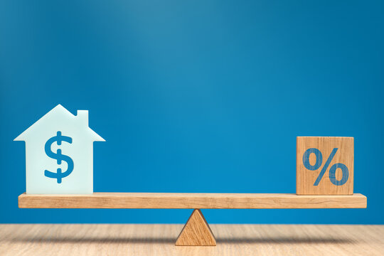 Mortgage interest rate in USA. Increase or decrease in property value. Model of a house with a dollar symbol on the scales in equilibrium with a percent sign. Banner on financial topics.