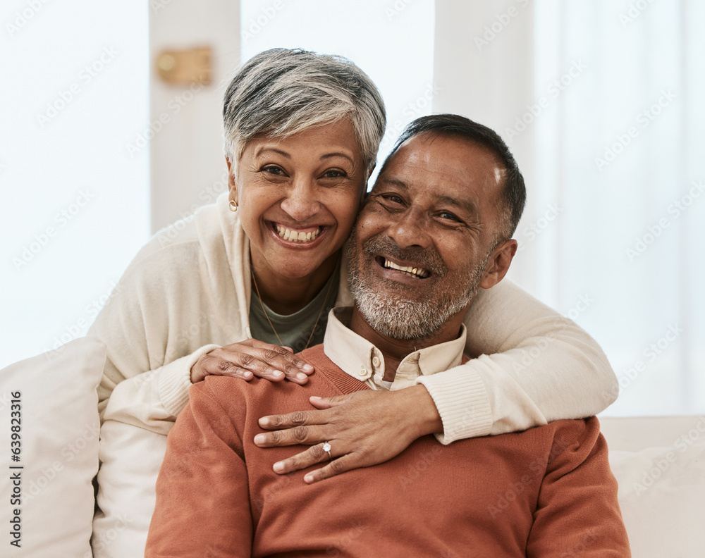 Sticker Smile, portrait and senior couple hug on sofa in living room relax, laugh and bond in their home. Face, smile and old man embrace elderly woman in a lounge with love, satisfied and enjoy retirement