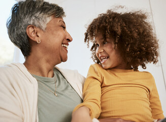 Grandmother, kid and funny laugh in home, bonding for connection and having fun playing together. Grandma, happy and smile of girl child, support and care for love in living room of interracial house