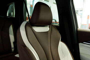 Modern Luxury car inside. Interior of prestige modern car. Comfortable leather brown seats....