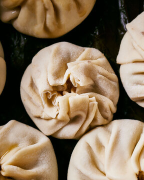 Close Up Of Raw Dim Sum On A Black Background. Detailed.