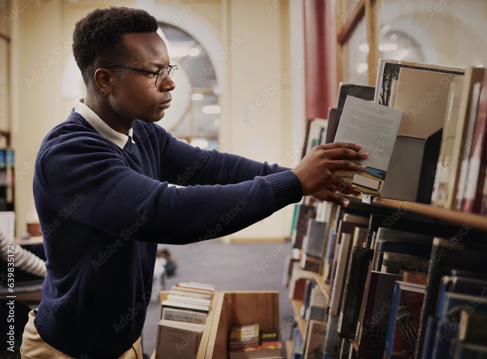Poster University, research and man in a library reading and learning on campus for knowledge and education in college. Smart, clever and young person in an academy with books on a shelf for an exam