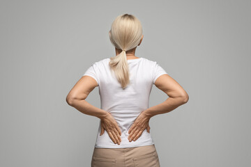 Unrecognizable Blonde Woman Suffering Body Ache Or Kidneys Pain