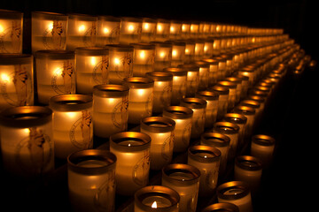 A photo of some lights candle in notre dame de paris, france