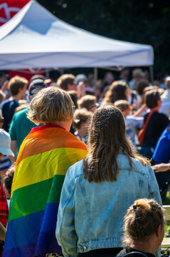 Woman wearing a rainbow colored pride flag on a local pride festival in Lund Sweden