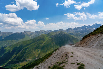 A red pickup truck driving on dirt roads on high plateau roads