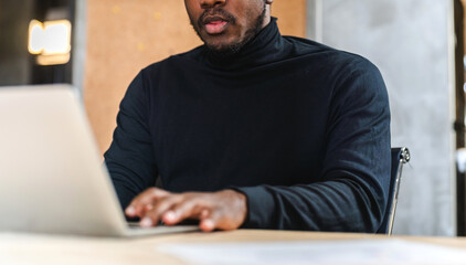 Young black african man relaxing using laptop computer working and startup idea at office.Young creative african man working and typing on keyboard smart online at company