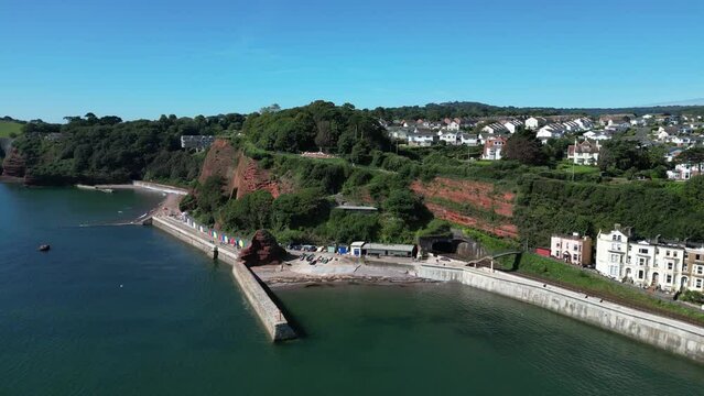 Dawlish, South Devon, England: DRONE VIEWS: An Intercity mainline train enters a railway tunnel near the popular UK holiday resort of Dawlish.