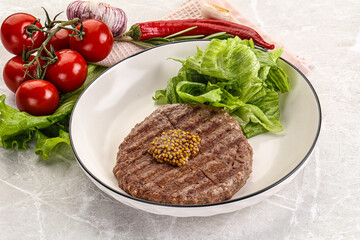 Frilled beef burger cutlet with iceberg