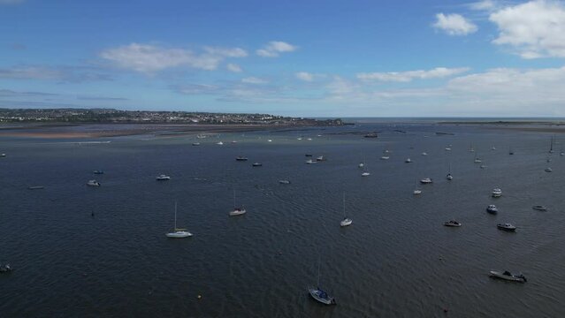 Exmouth, South Devon, England: DRONE VIEWS: River Exe estuary and boats; the town of Exmouth and the River Exe mouth in the background, Exmouth is a major UK holiday resort (Clip 1).