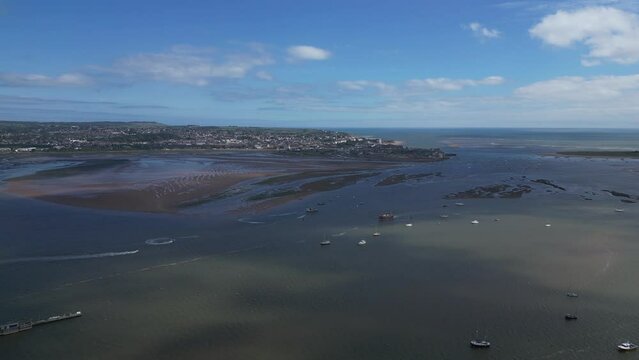 Exmouth, South Devon, England: DRONE VIEWS: River Exe estuary and boats; the town of Exmouth and the River Exe mouth in the background, Exmouth is a major UK holiday resort (Clip 2).