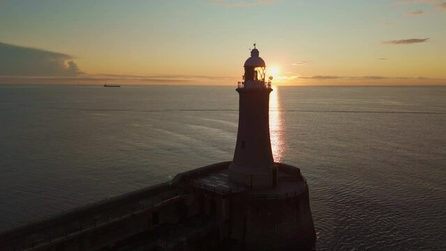 Tynemouth North Lighthouse Panning Drone Shot Sunrise Sun Passing Through Lighthouse Glass Watermark
