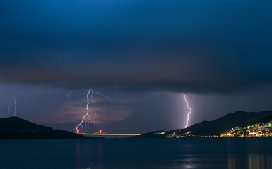 Lightning over the sea. Thunderstorm at night.