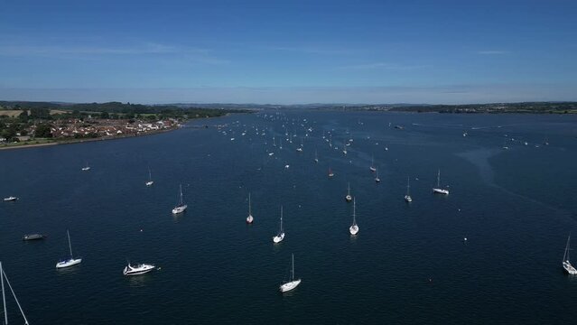 River Exe, South Devon, England: DRONE VIEWS: A high angle view of yachts and boats moored on the River Exe, which is a popular UK holiday and tourist destination (Clip 1).