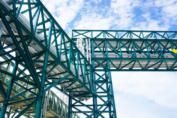 Green pipe rack and pipe bridge in oil and gas project at construction site