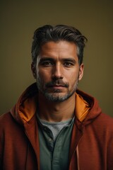 Obraz premium Portrait of man in hoodie sweater on yellow background