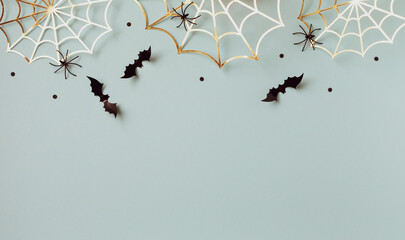 Halloween party decorations from bats, spider web and confetti top view. Happy halloween minimal...