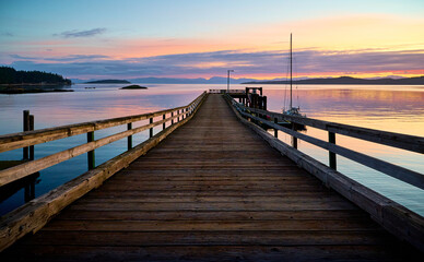 Fototapeta na wymiar sailboat at the pier. Sunset over the sea Halfmoon Bay. Sunshine Coast, British Columbia, Canada