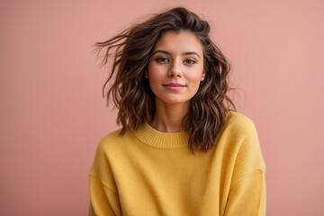 Funny young brunette woman girl in yellow sweater posing isolated on pastel pink wall background studio portrait. People sincere emotions lifestyle concept. Mock up copy space
