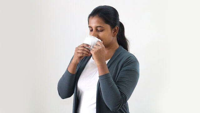Indian young women drinking coffee or tea with good feel