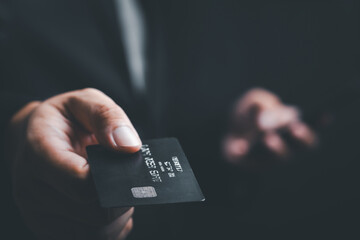 businessman is using a credit card with a smartphone for financial transactions. Online banking...