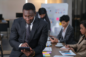 Black African businessmen using tablet analyze data in the meeting room
