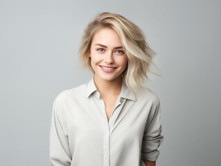 Portrait of a smiling girl on a light gray background.