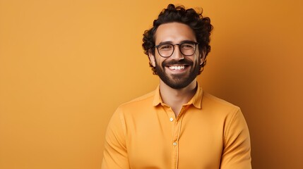 Fototapeta premium Portrait of a smiling man in a shirt on an orange background.