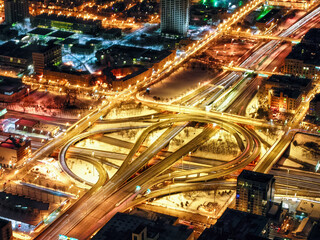 Fototapeta na wymiar Long exposure, night time aerial view of the Jane M. Byne Interchange in Chicago, Illinois. The interchange is a major transportation hub, and it connects several major highways.