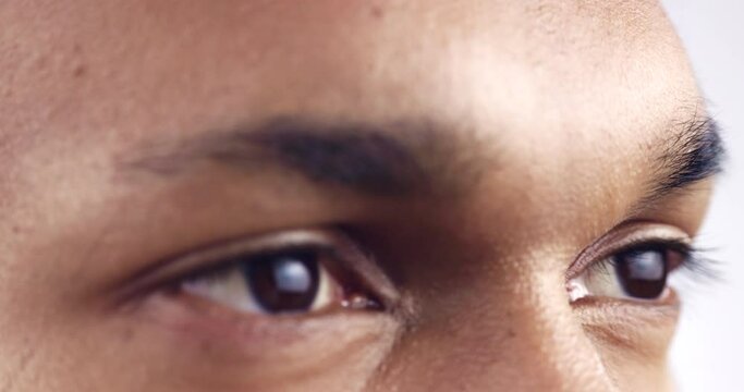 Eyes, future and vision with a man in studio on a white background inspiration while thinking of an idea. Face, mindset and eyesight with the face of a young person closeup for an optometry exam