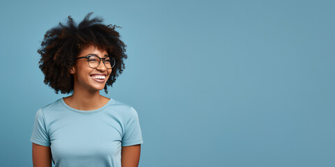 Attractive african american woman wearing blue tshirt and glasses. Isolated on blue background