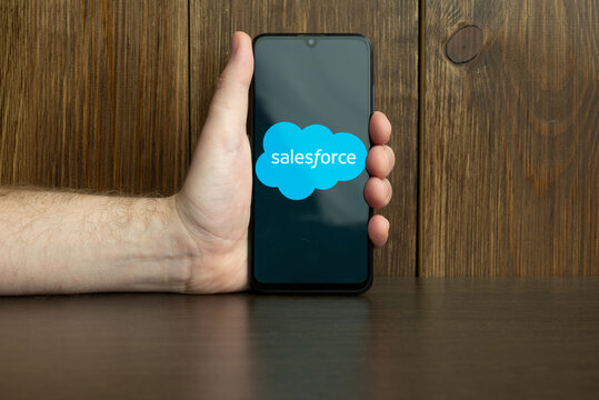 Kyoto city, Japan - July 31, 2023: Salesforce.com displayed on a smartphone near modern laptop on wooden background