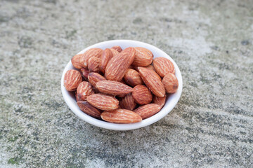 brown almonds on a white bowl
