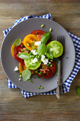 salad with tomatoes slices basil and feta cheese