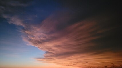 Caption: Captivating Dusk Sky: A Spectacular Display of Beautiful Clouds and the Brilliant Venus Illuminating the Horizon.