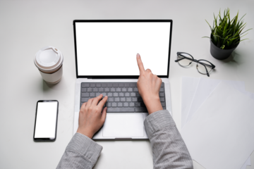 Freelancer using transparent laptop screen skillfully managing projects communicating via smartphone strategizing for success