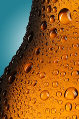 neck of a bottle with beer in drops close-up
