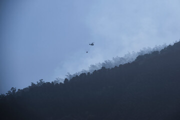 Wildfire Suppression: Helicopter in Action Against Blaze