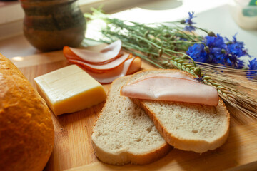 Traditional sandwich with a slice of sausage on a slice of bread and cheese