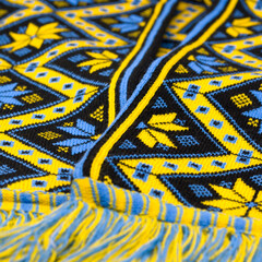 Yellow-blue knitted scarf with Ukrainian ornament. Christian protective ornament. Embroidered pattern. Vyshyvanka. Traditional clothes. Mother's star.
