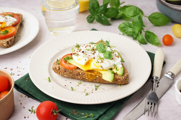 Fototapeta na wymiar Plate of tasty sandwich with egg on light background