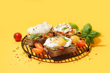 Grid of tasty sandwiches with egg on yellow background