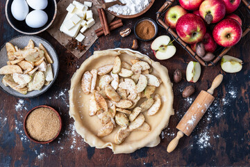 Cooking baking concept. Making rustic American style apple pie, top view on table with ingredients