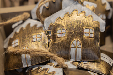 Christmas metal houses with a pattern lying on the counter of a street toy market